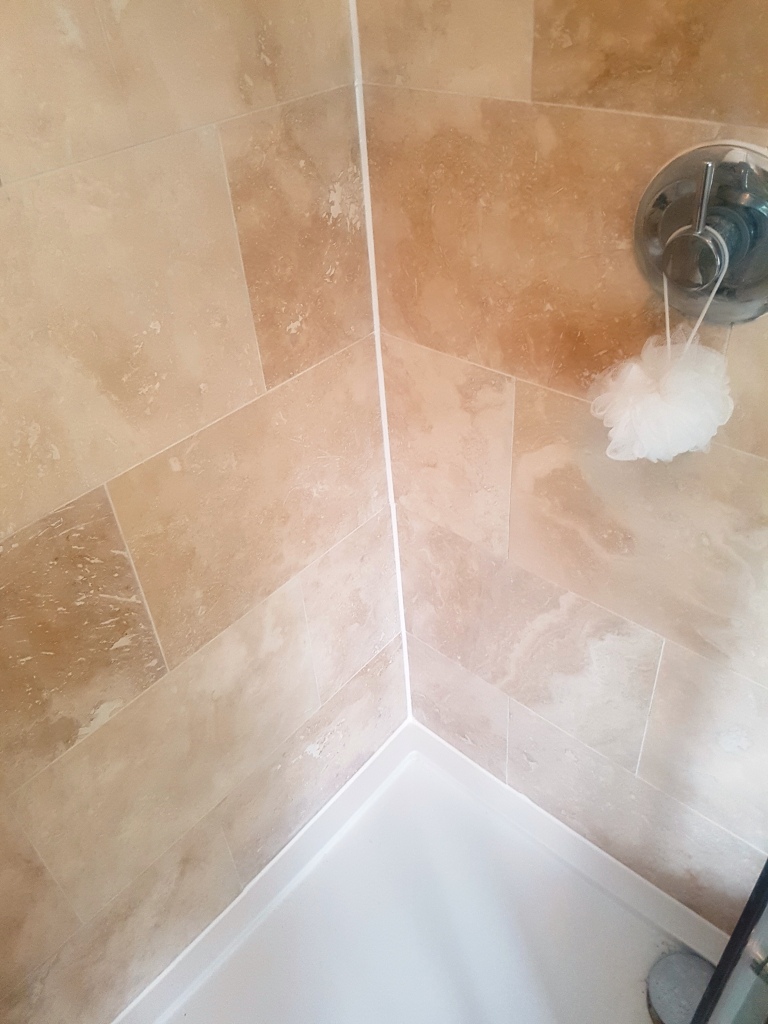 How do you clean travertine shower tiles?